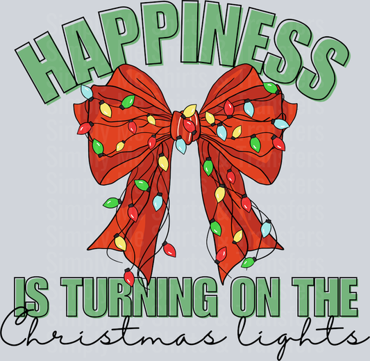 HAPPINESS IS TURNING ON THE CHRISTMAS LIGHTS